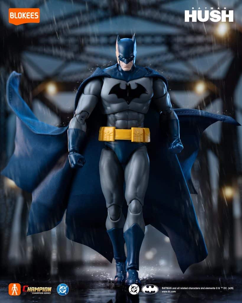 A highly detailed action figure of Batman, wearing a blue and gray suit with a yellow utility belt, posed dramatically against a rainy urban backdrop.