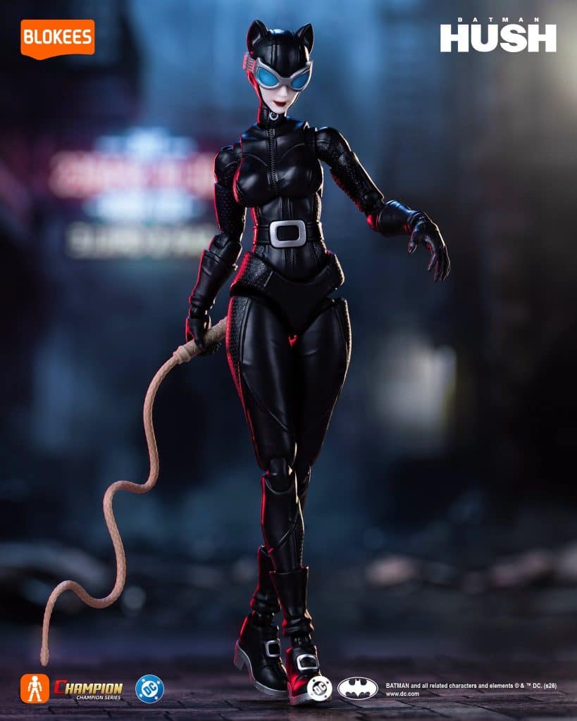 A detailed action figure of Catwoman, dressed in a black costume with cat ears and sunglasses, holding a whip, set against a blurred urban background.