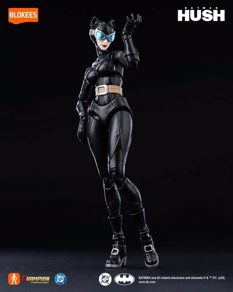 Figure of a female character in a black feline costume with cat ears and blue goggles, posing with one hand raised. Background is dark.