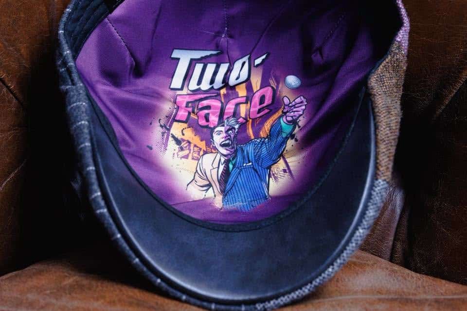 Interior of a hat featuring a colorful comic-style artwork of a character labeled 'Two-Face,' depicted in a suit with an expressive pose against a purple background.