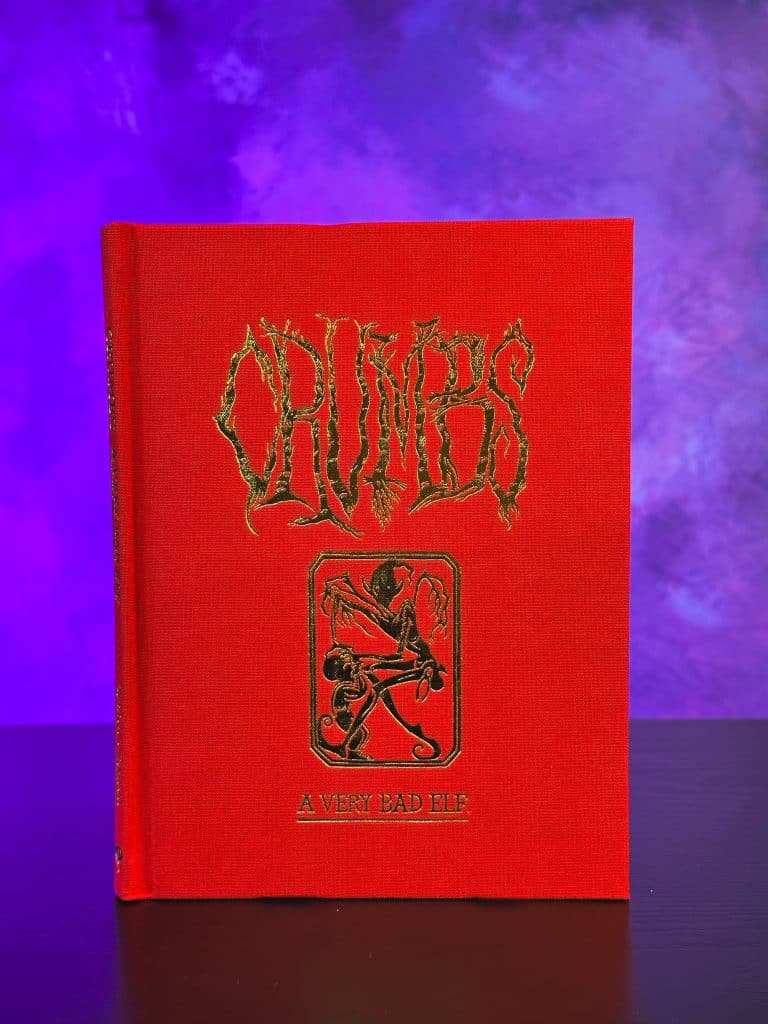 A red book titled 'CRUMBS: A Very Bad Elf' with gold lettering and an illustration on the cover, set against a purple background.