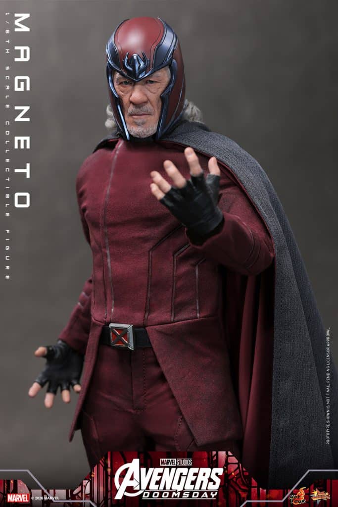 A collectible figure of Magneto in a maroon costume and helmet, posing with one hand raised and a stern expression. The figure features detailed textures and a gray cape, set against a neutral background.