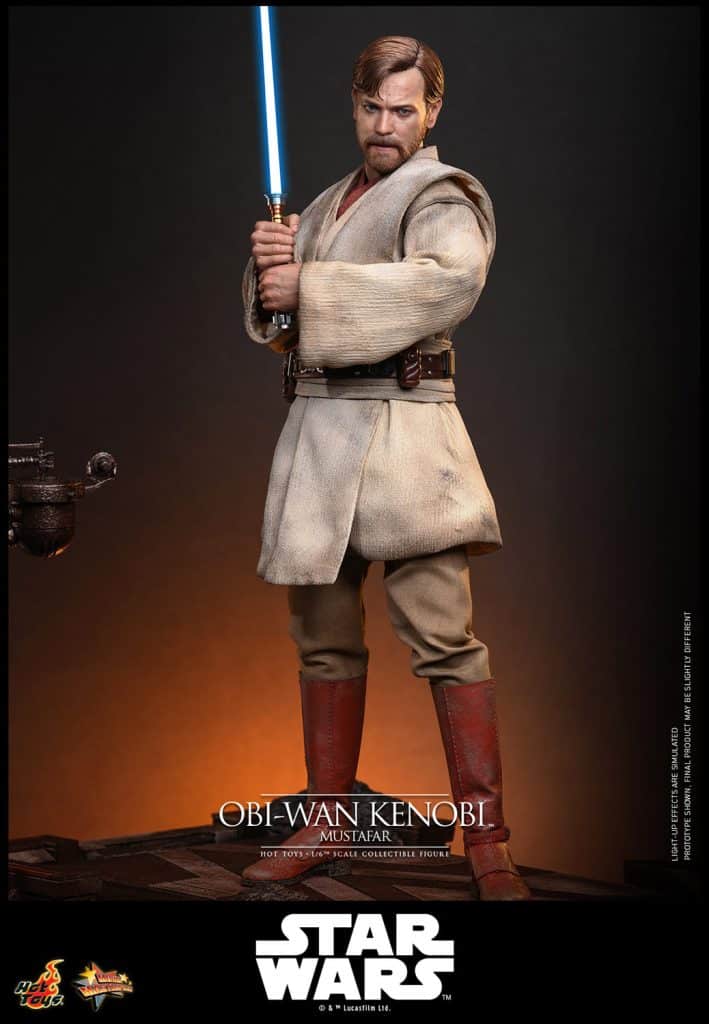 A detailed collectible figure of Obi-Wan Kenobi from Star Wars, standing with a blue lightsaber in a desert setting.