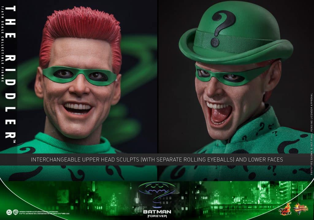A highly detailed collectible figure of The Riddler from Batman Forever, showcasing interchangeable head sculpts with rolling eyeballs and expressive facial features.