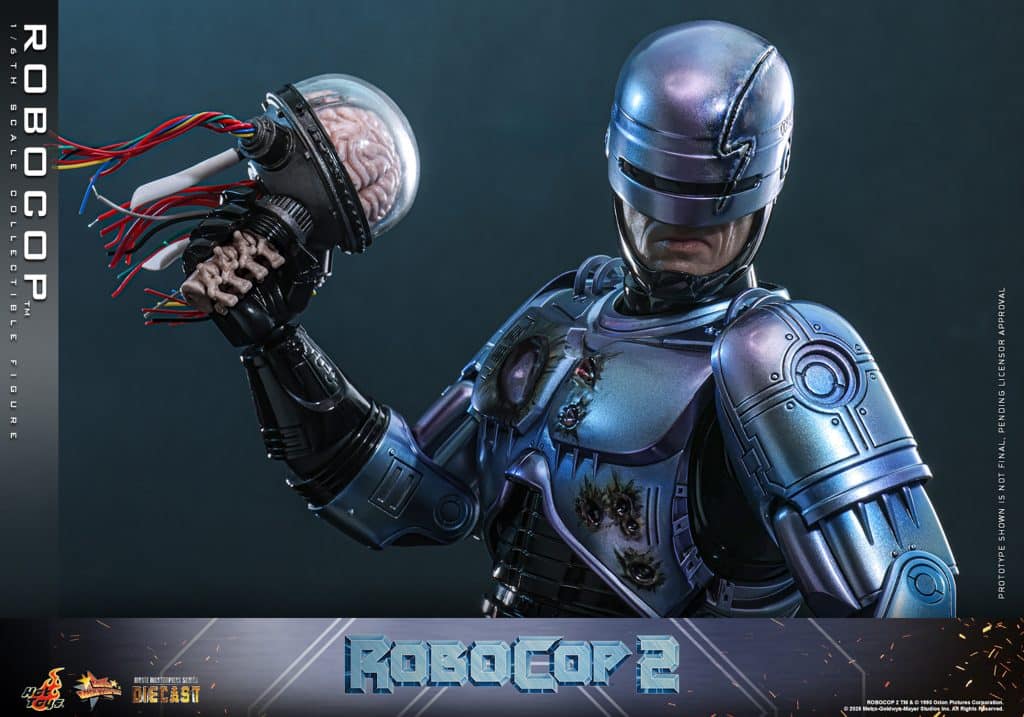 A collectible 1/6 scale figure of Robocop from Robocop 2, featuring intricate details, a silver armored suit, and a removable helmet, showcasing mechanical components and wiring.