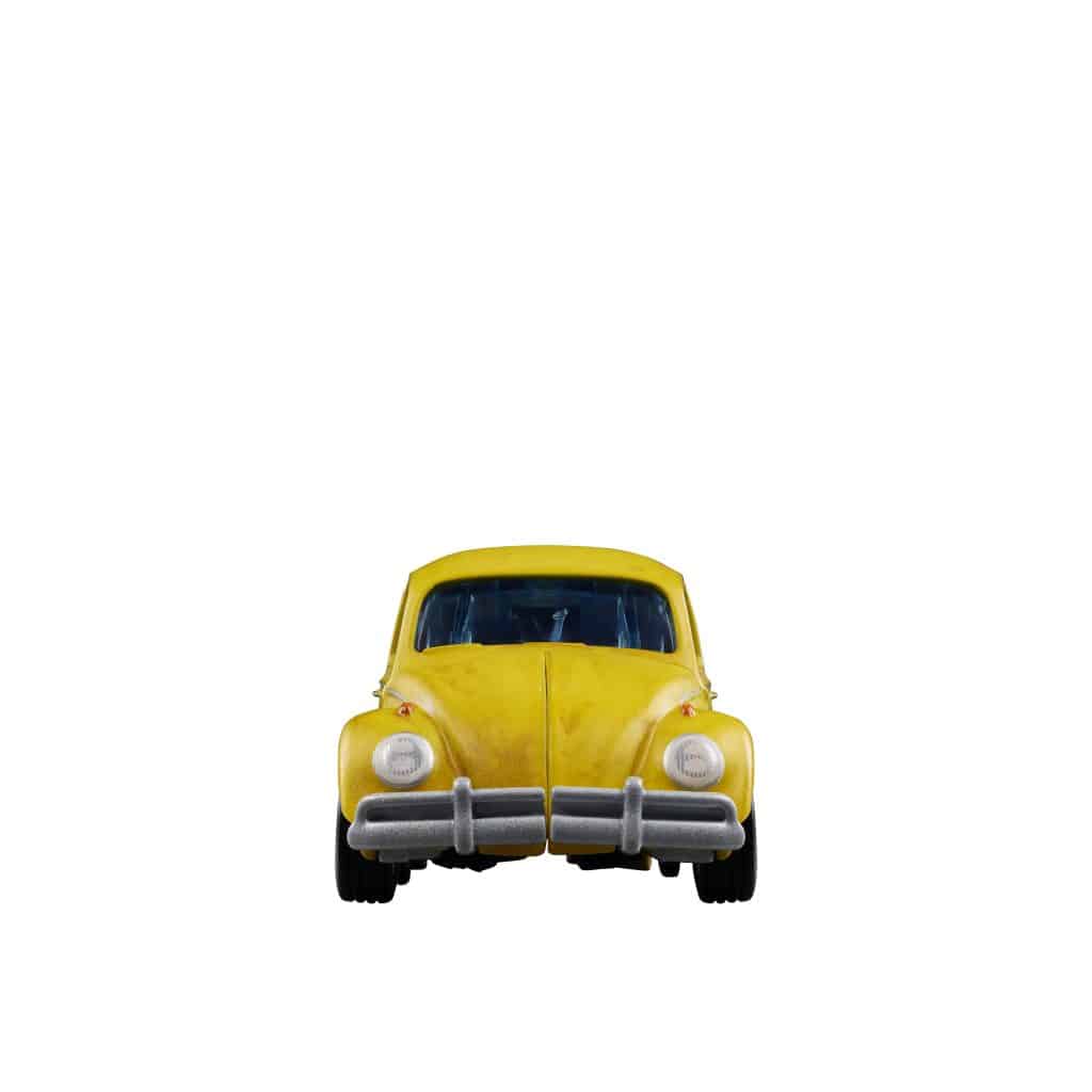 Front view of a vintage yellow car with a rounded shape and distinctive headlights.