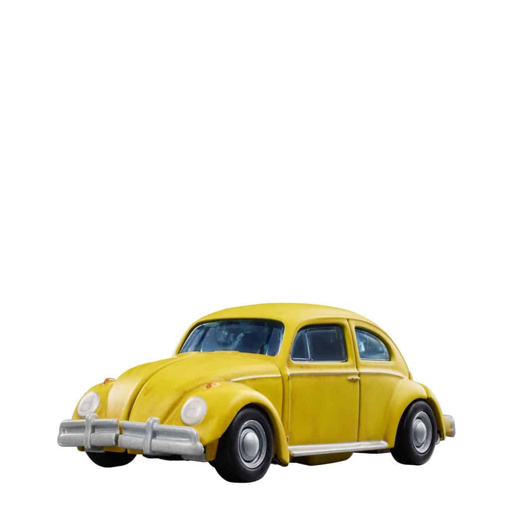 A yellow vintage car model with rounded features and chrome accents.