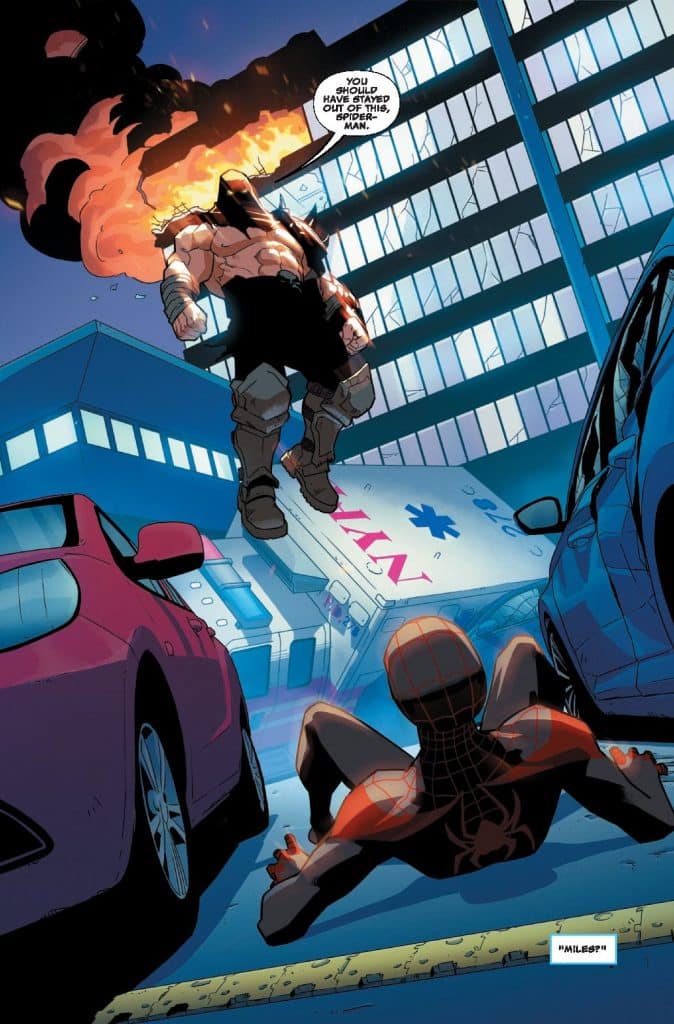 A superhero in a red and black costume, resembling Spider-Man, crouches on the ground looking up at a muscular antagonist in a dark outfit, who is floating above an explosion in a city setting with buildings and cars around.