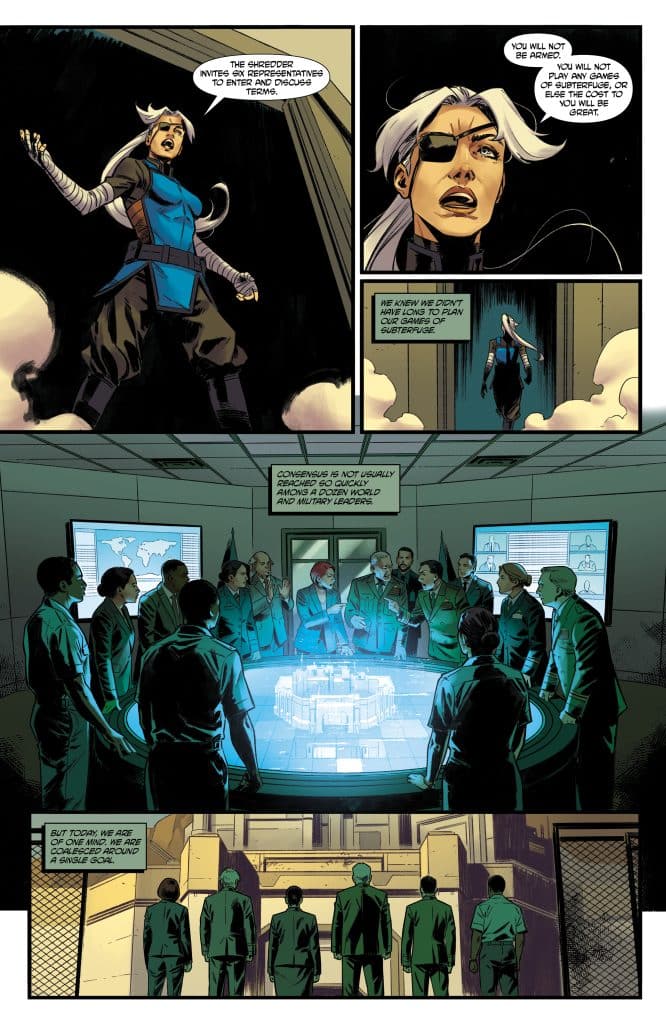 A comic book panel depicting a group of diverse military personnel gathered around a high-tech circular table, discussing strategy. One character, a woman with an eye patch and white hair, is speaking passionately. The setting features digital screens displaying maps and military data.