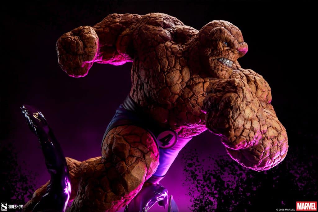 A detailed statue of The Thing from the Fantastic Four, showcasing his rocky texture and muscular build against a dark, purple background.