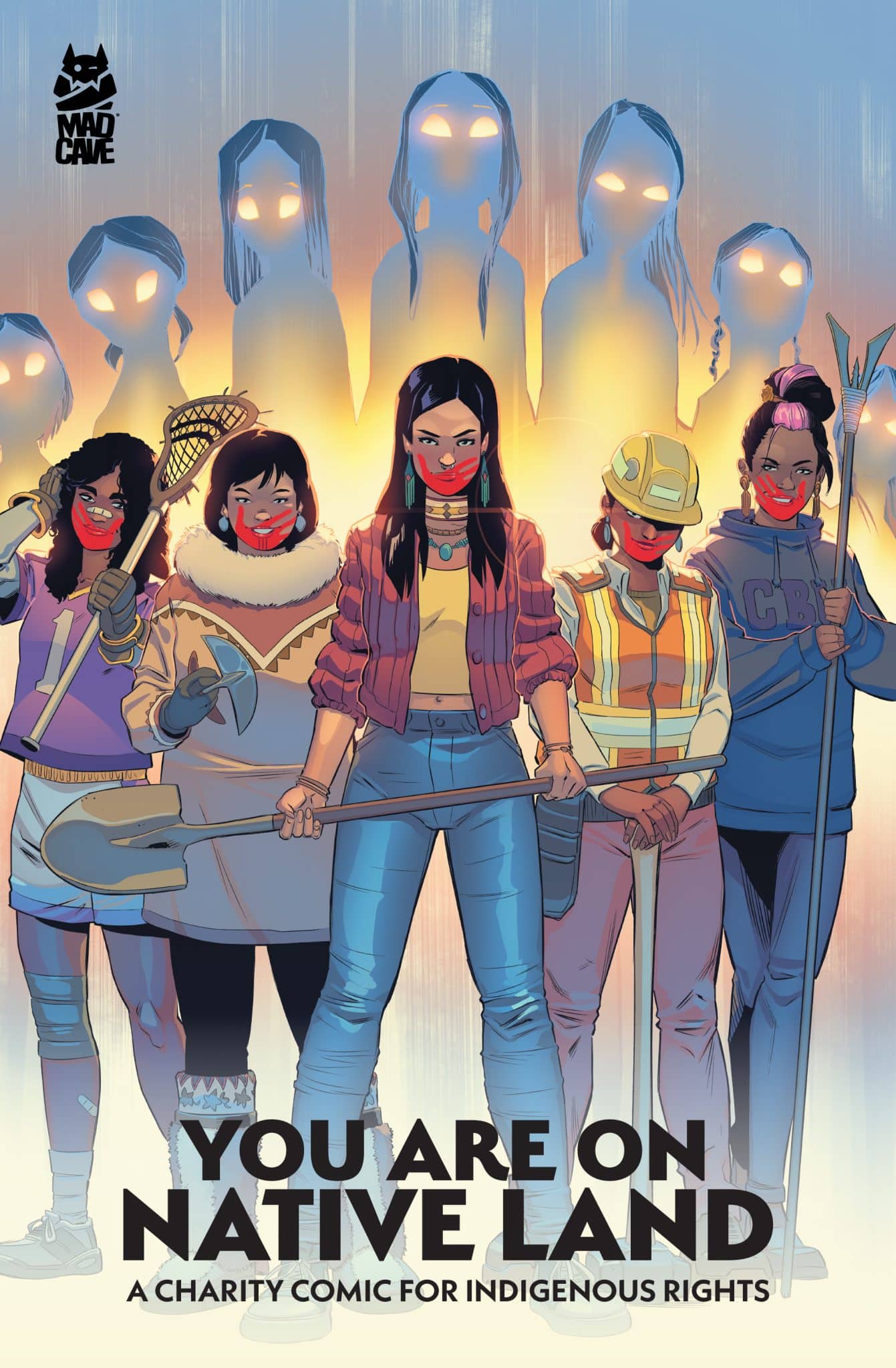 Illustration of five Indigenous women standing confidently, with a backdrop of shadowy figures. They are holding various tools and wearing traditional clothing. The title 'YOU ARE ON NATIVE LAND' is prominently displayed, alongside the subtitle 'A CHARITY COMIC FOR INDIGENOUS RIGHTS'.