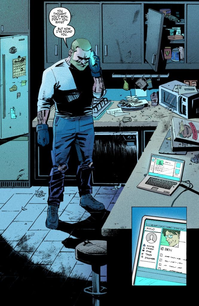 A muscular man with short hair and a beard stands in a messy kitchen, holding a phone to his ear with a serious expression. Papers and a laptop are scattered on the counter, displaying a profile with the name 'Ben'. The kitchen has an unkempt appearance, with various items, including an open cupboard and cluttered surfaces.