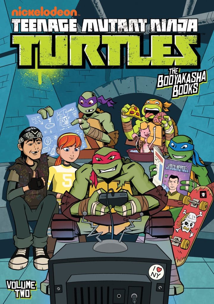 Cover art for 'Teenage Mutant Ninja Turtles: The Bodyakasha Books Volume Two' featuring the turtles and friends gathered around a TV playing video games.