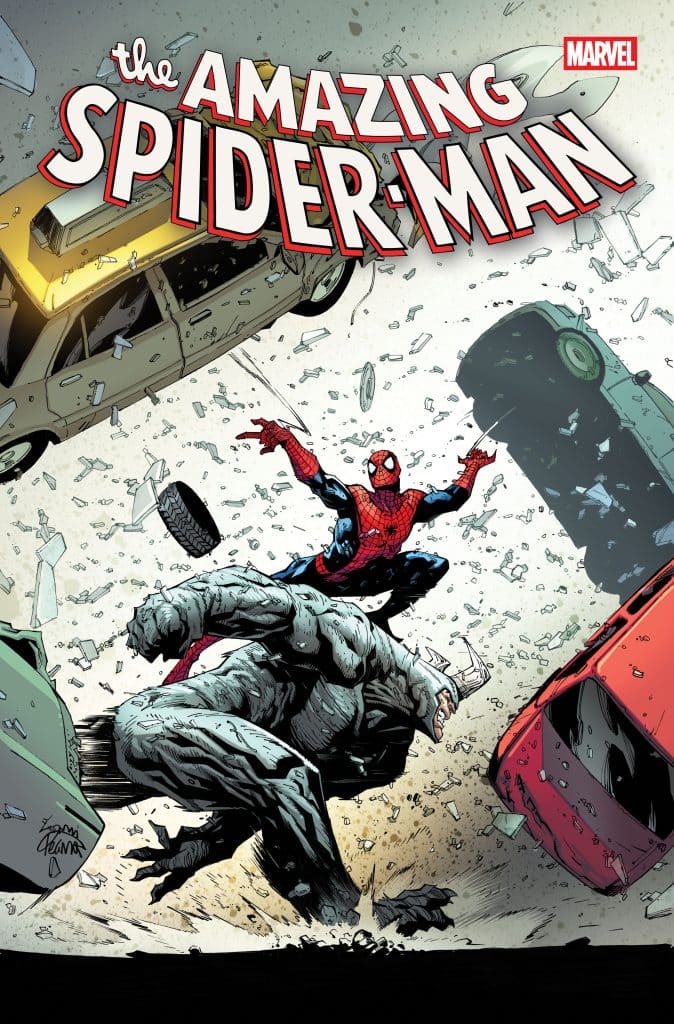 Comic book cover featuring Spider-Man swinging into action, battling a monstrous figure amidst flying debris and overturned vehicles.