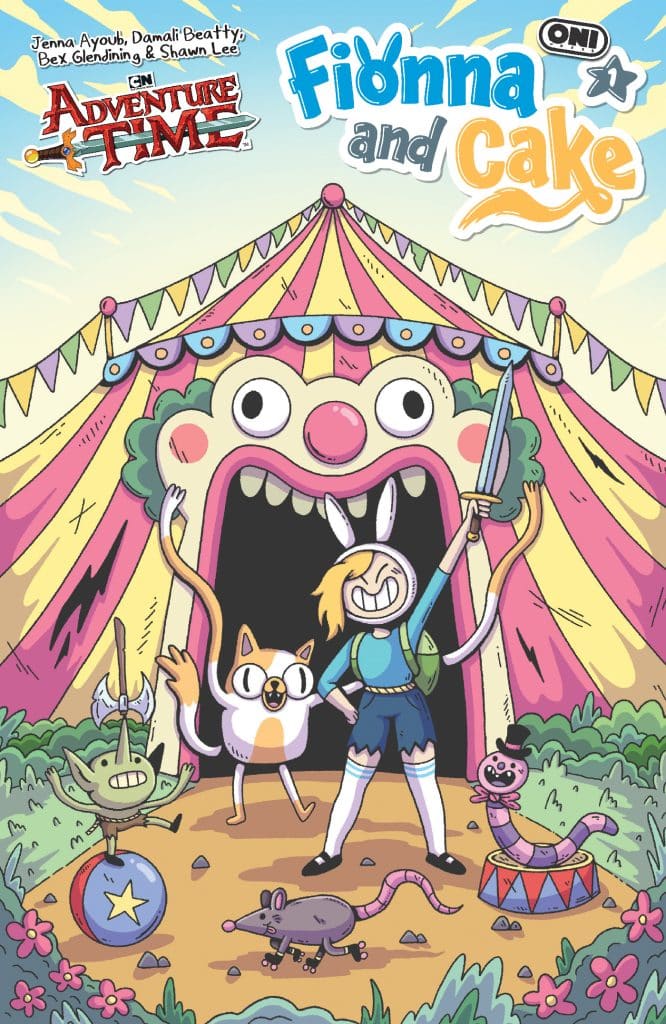 A colorful comic book cover featuring Fionna, a female character with rabbit ears, holding a sword in front of a whimsical circus tent. Alongside her is Cake, a cat-like creature, and various other playful animals. The title reads 'Adventure Time: Fionna and Cake'.
