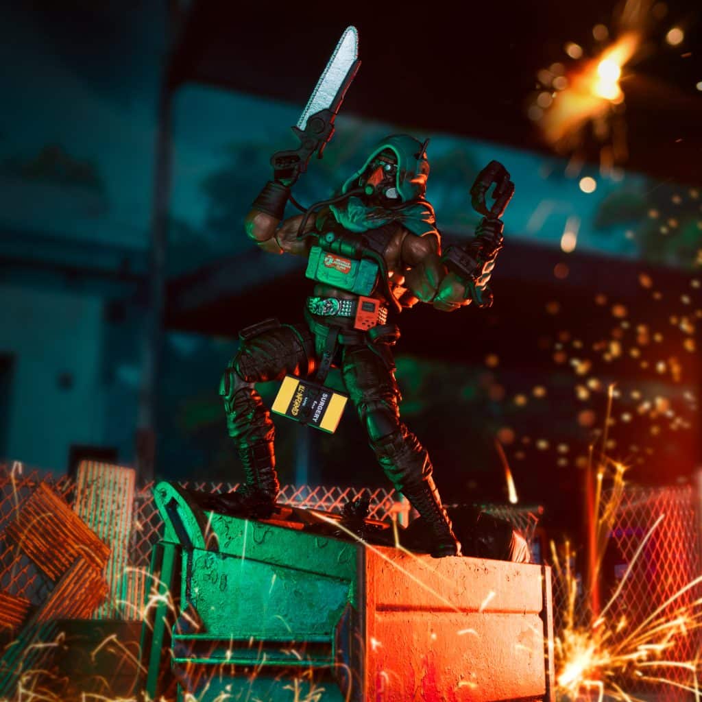 A dynamic action figure of a warrior with a chainsaw stands triumphantly on a green dumpster, set against a backdrop of colorful lighting and sparks.