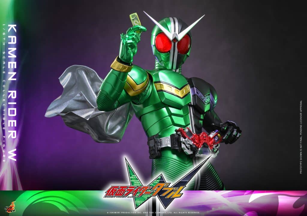 A dynamic action figure of Kamen Rider W, dressed in a green suit with red eyes, holding a card and posing heroically. Featuring a cape and a detailed belt with accessories.
