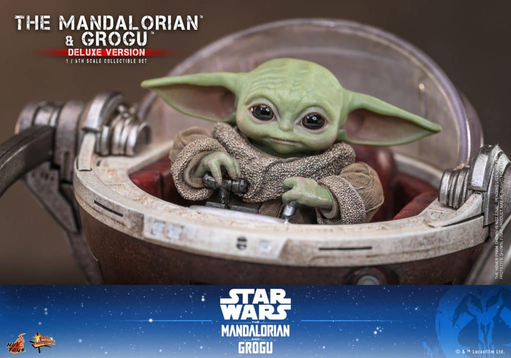 A collectible figure of Grogu from The Mandalorian, sitting in a hover pod with a focused expression, showcasing detailed features like large eyes and green skin.