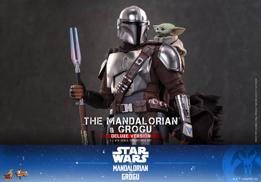 A detailed figure of The Mandalorian character, wearing armor and holding a spear, with Grogu perched on his shoulder, set against a dark background.