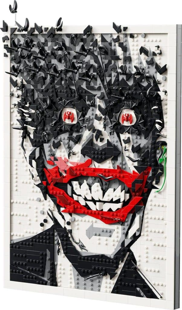 A LEGO art piece depicting a stylized face with a wide, menacing smile, featuring chaotic elements that suggest fragmentation and distortion.