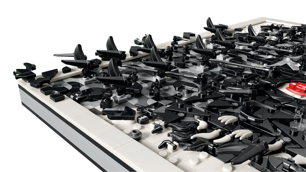 A close-up view of a complex arrangement of black and white LEGO pieces, showcasing various shapes and sizes, with some pieces arranged in a decorative pattern.