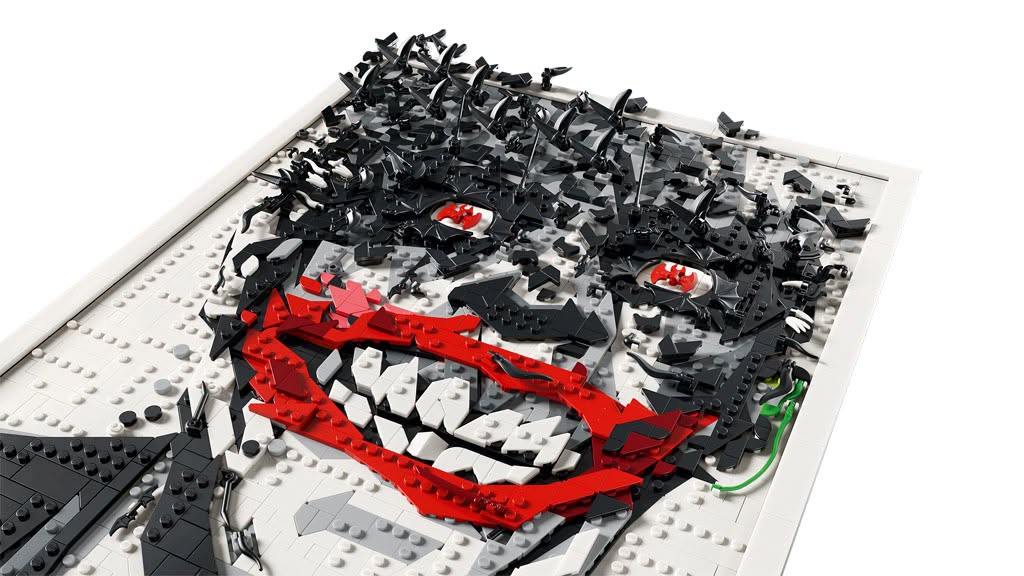 A detailed close-up of a LEGO mosaic depicting a stylized face with a wide smile, using primarily black, white, and red blocks against a white background.