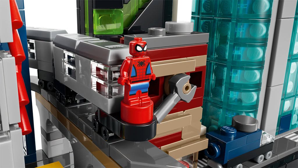 A close-up image of a Spider-Man LEGO figure positioned on a colorful building structure made of various LEGO bricks.