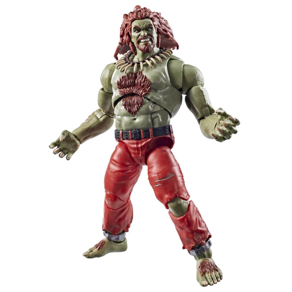 Action figure of a muscular character with green skin, red hair, and wearing red pants. The figure is posed with arms raised and a fierce expression.