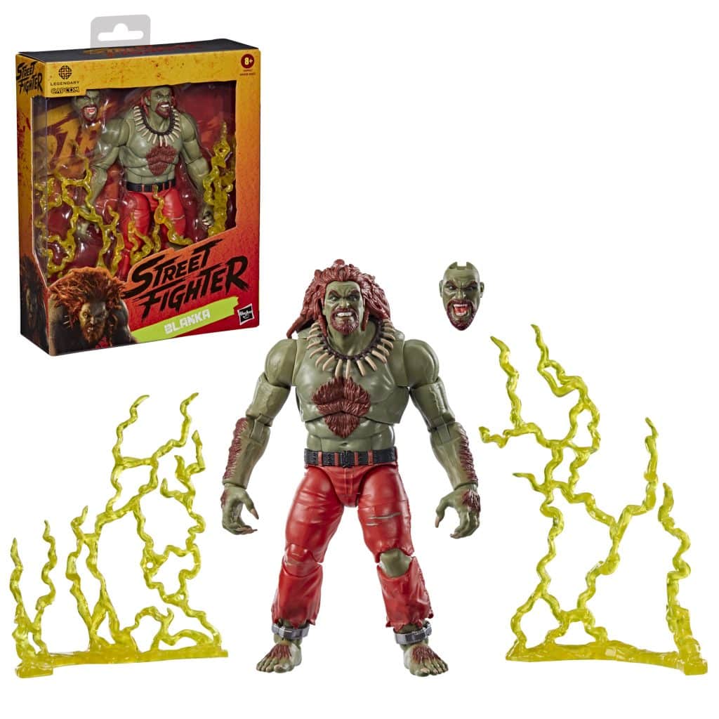 A collectible figure of Blanka from Street Fighter, featuring green skin, a lion-like mane, red pants, and accessories including an alternate head and electric yellow effect pieces, displayed with its packaging.