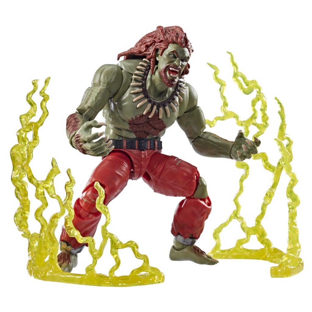 Action figure of a muscular green character with red hair and a necklace, posed dramatically amidst yellow energy effects.