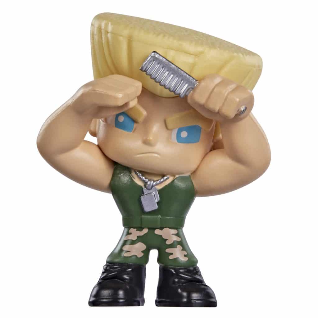 A toy figurine of a muscular character with a large, yellow hairstyle, wearing a green tank top and camouflage pants, holding a comb and saluting.