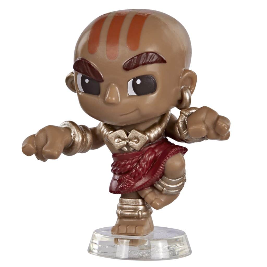 A cute, stylized figurine of a character with a bald head, tribal markings, and wearing a red and gold outfit, posed in a dynamic stance on a clear base.