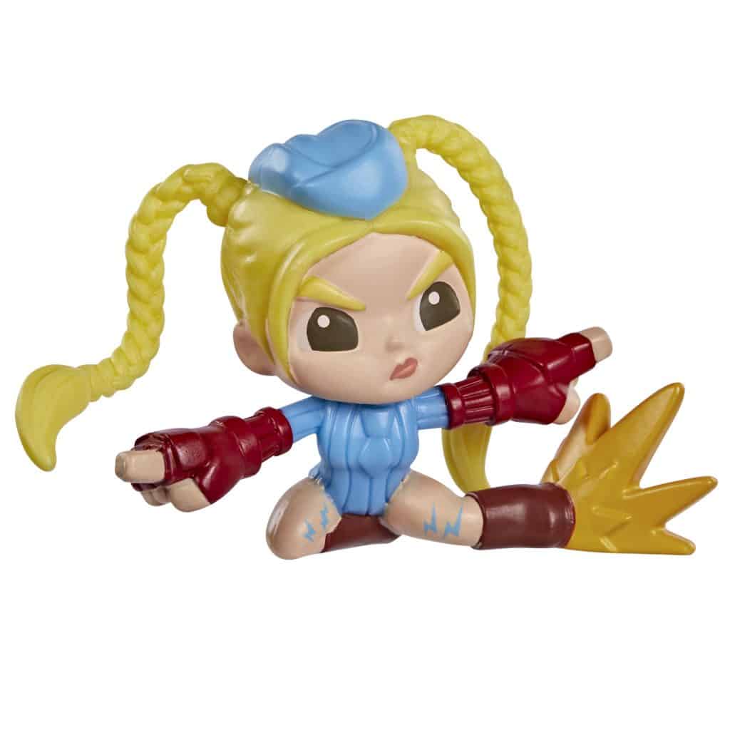 A stylized collectible figure of a character with blonde hair in pigtails, wearing a blue outfit and red gloves, posed dynamically with one leg extended and a burst effect behind it.