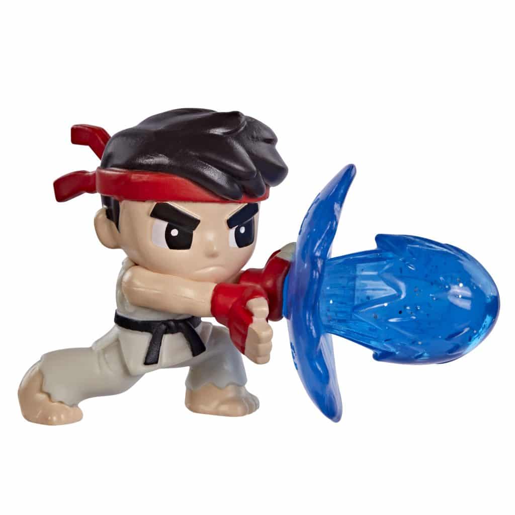 A small action figure of a martial artist in a white gi with a red headband, wielding a blue energy sword.
