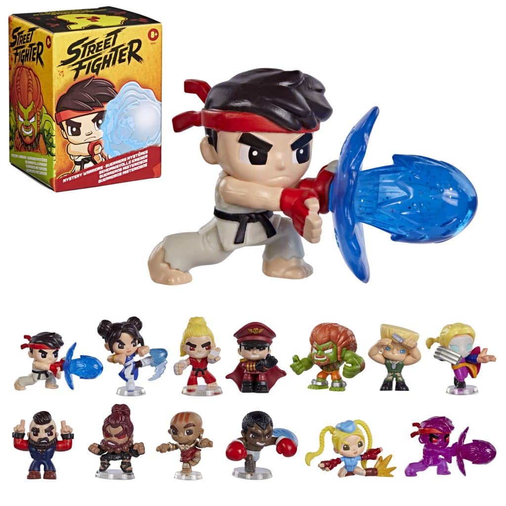 A collection of Street Fighter toy figurines displayed in front of their packaging, featuring characters like Ryu, Chun-Li, and Ken, with Ryu performing a special move.