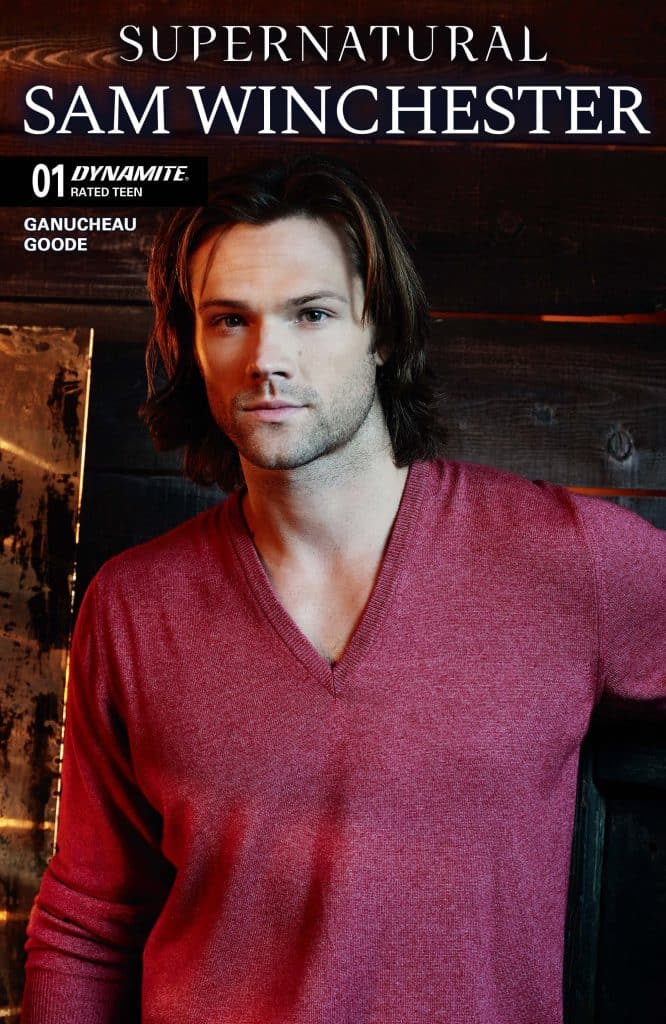 A man with long, dark hair wearing a red v-neck sweater, looking directly at the camera, with a rustic background and the title 'Supernatural: Sam Winchester' prominently displayed.