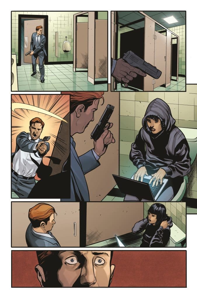 A tense scene in a bathroom with a man in a suit holding a gun while confronting a hooded figure sitting with a laptop.