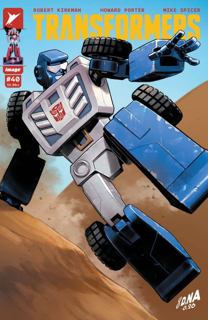 Comic book cover featuring a blue robot from the Transformers series, posed dynamically on a sandy terrain.