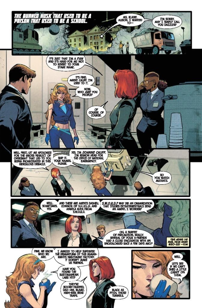 A comic book panel featuring a conversation among four characters in a dimly lit room. One character with blonde hair and a blue outfit stands in front of three others, who are discussing an organization related to extraterrestrial studies. Dialogue bubbles convey their respective roles and a mission involving dismantling human experiments.